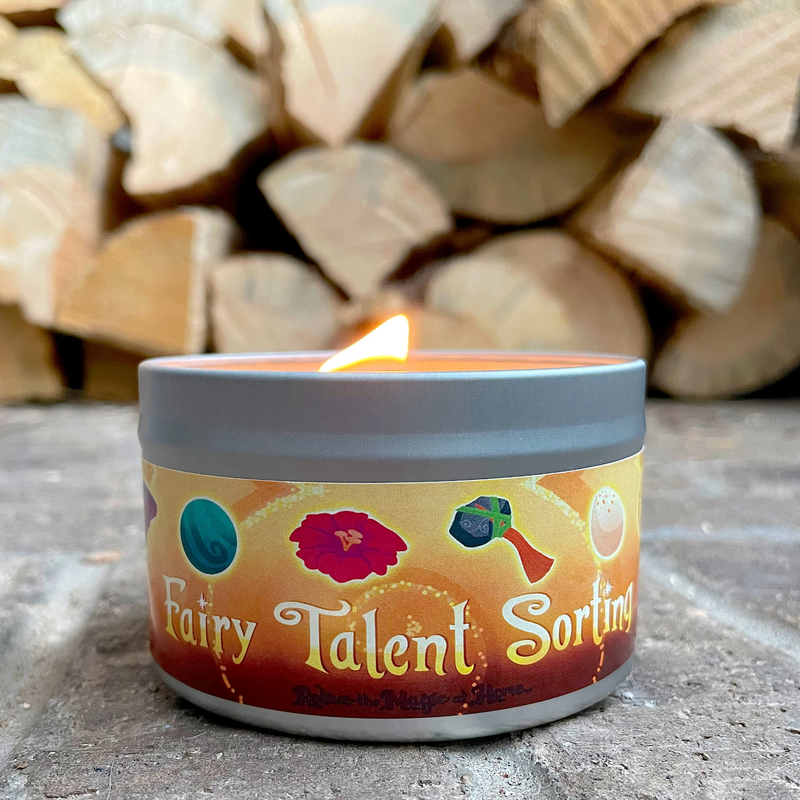 Candle in a container labeled 'Fairy Talent Sorting' with logs in the background