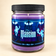 A purple wax candle in a clear glass jar with a black ribbed lid and a decorative label reading 'The Mansion' in glowing blue text, shown on a plain beige background.